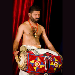 Musicians performing Kathakali music with traditional instruments, setting the rhythm for the dance.