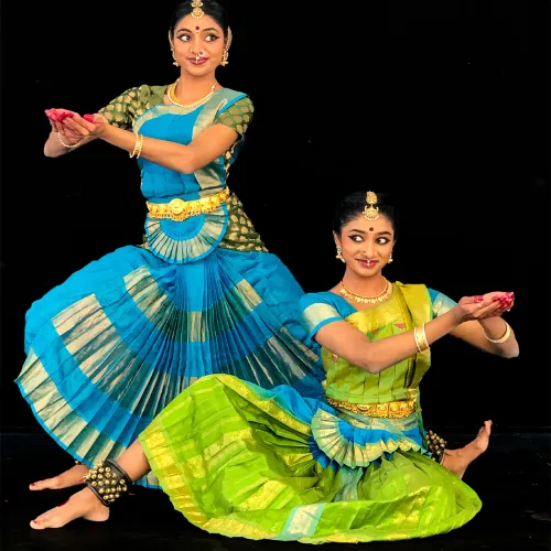 Young Kuchipudi dancer in vibrant costume performing traditional Indian dance move with expressive gestures.