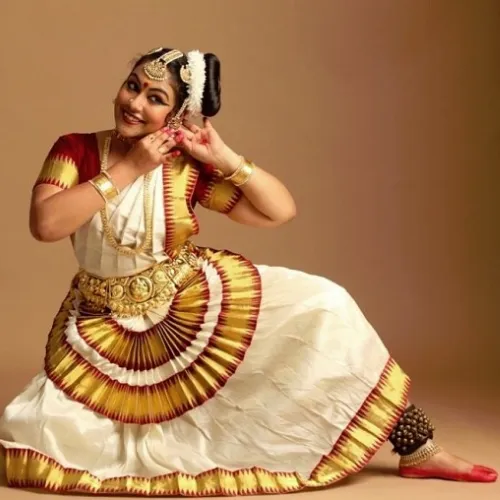 Graceful Mohiniyattam dancer in traditional attire performing with expressive hand gestures.