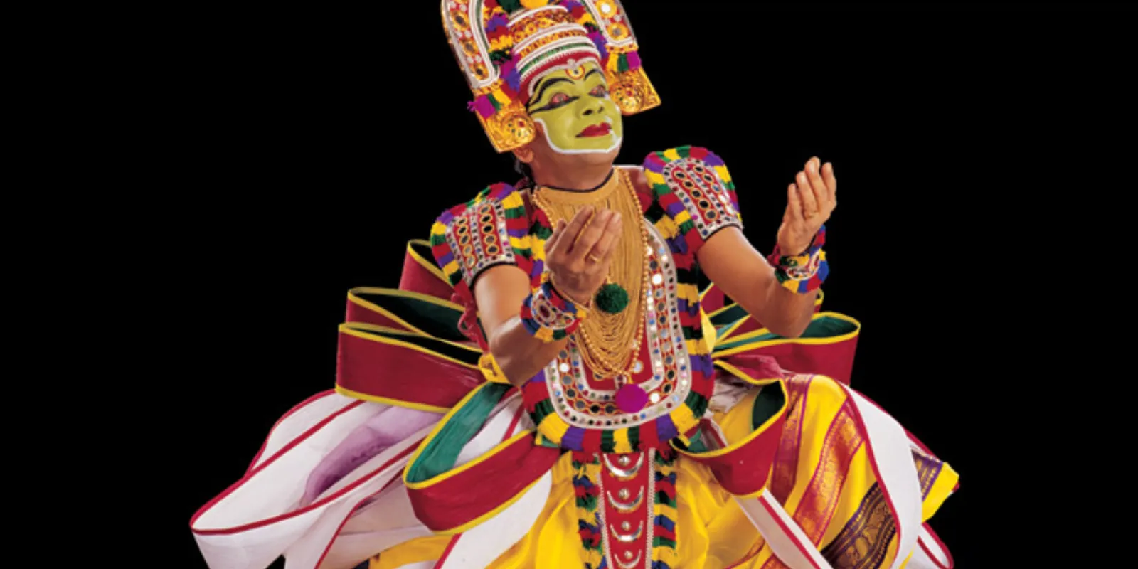 Ottam Thullal performer in colorful costume showcasing lively dance movements.
