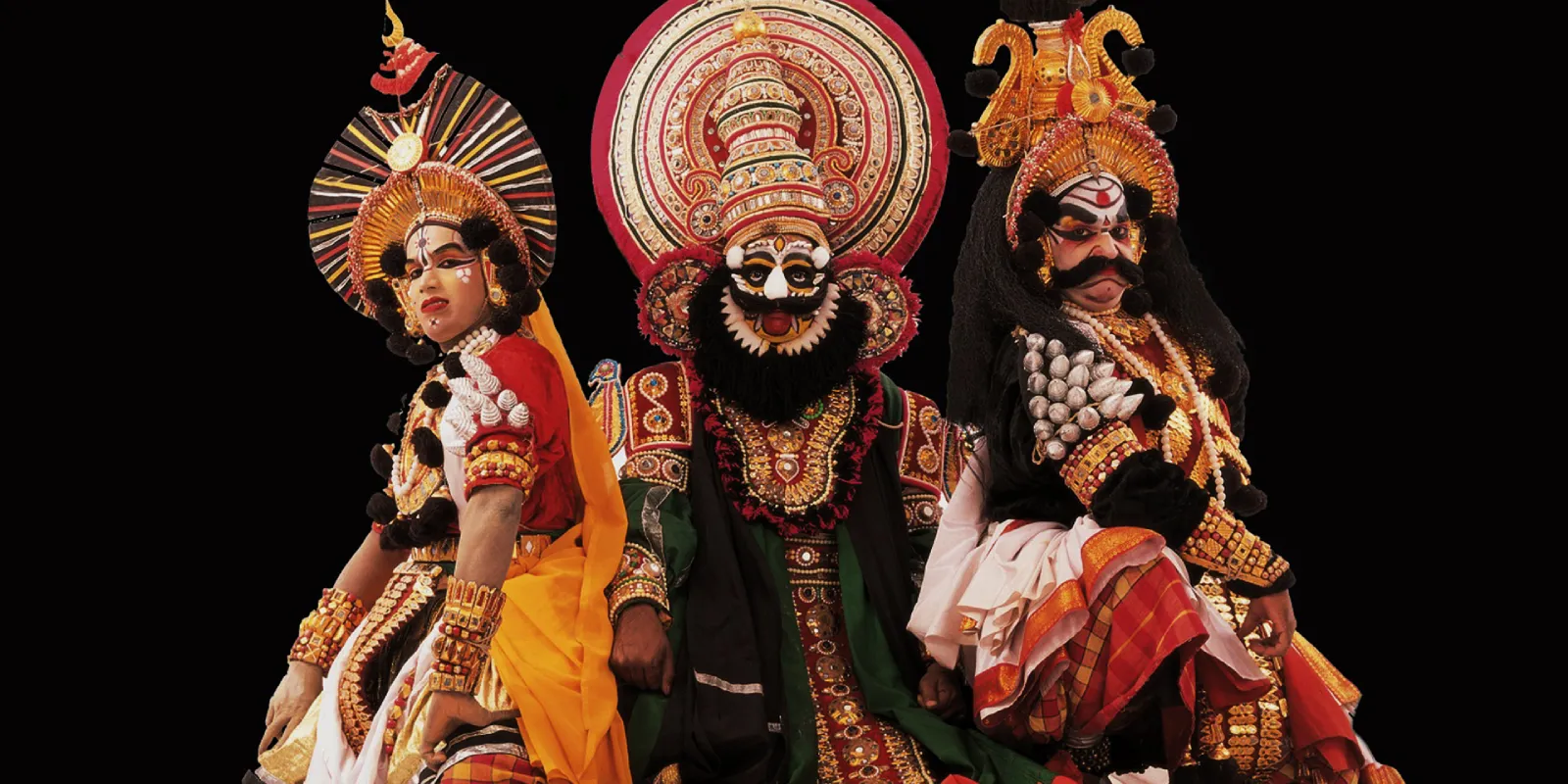Yakshaganam performer in colorful costume showcasing dramatic expressions and lively dance on stage
